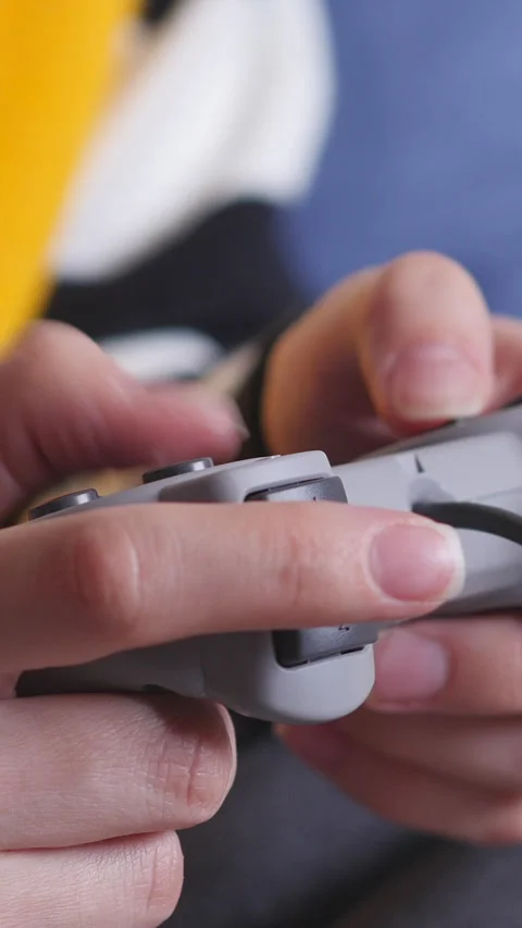 Hands Holding Game Controller And Pressing Button. Vertical. Stock Footage 297862241