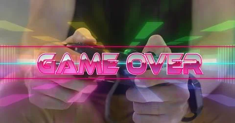 Hands holding game controller with vibrant game over text overlay Illustrazione stock
