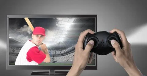 Hands holding gaming controller  with baseball player on television Foto stock