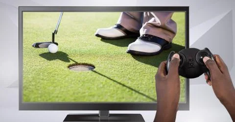 Hands holding gaming controller  with golf player on television Foto stock