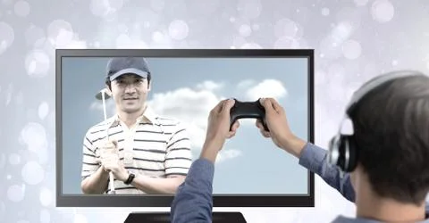 Hands holding gaming controller  with golf player on television Stock Photos