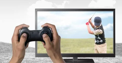 Hands holding gaming controller  with golf player on television Stock Photos