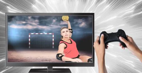 Hands holding gaming controller  with handball player on television Stock Photos