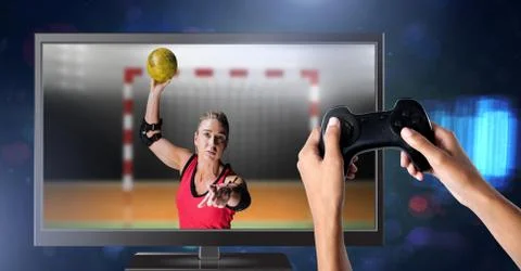 Hands holding gaming controller  with handball player on television Stock Photos