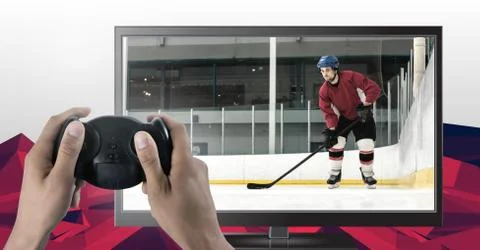 Hands holding gaming controller  with ice hockey player on television Stock Photos
