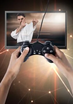 Hands holding gaming controller  with martial arts fighter on television Stock Photos