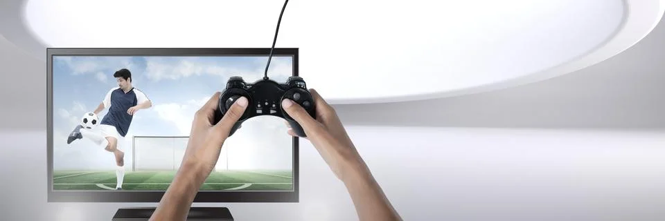 Hands holding gaming controller  with soccer player on television Stock Photos
