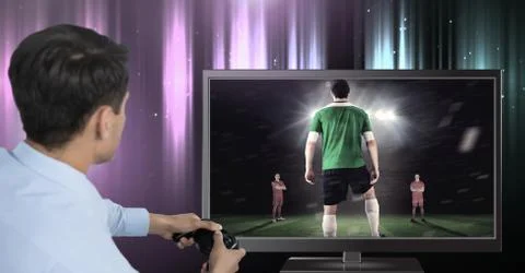 Hands holding gaming controller  with soccer player on television Stock Photos
