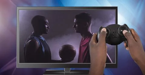 Hands holding gaming controller  with soccer player on television Stock Photos