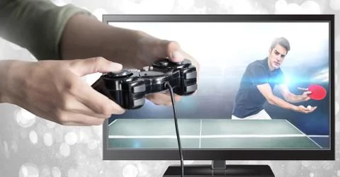 Hands holding gaming controller  with table tennis on television Stock Photos