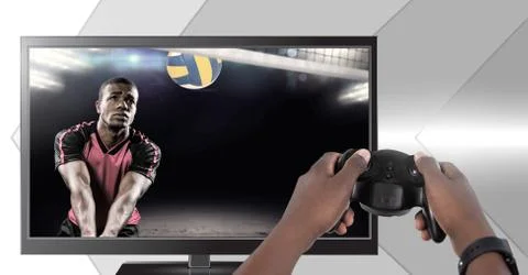 Hands holding gaming controller  with volleyball player on television Stock Photos