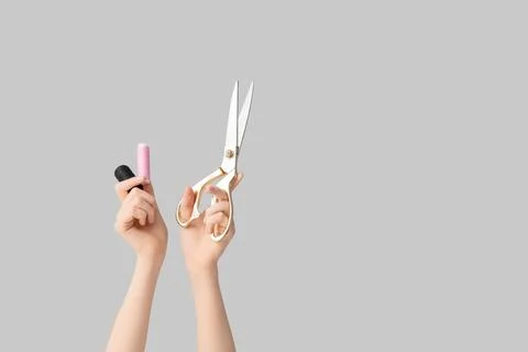 Hands holding golden tailor scissors and thread spools for sewing and craftin Stock Photos
