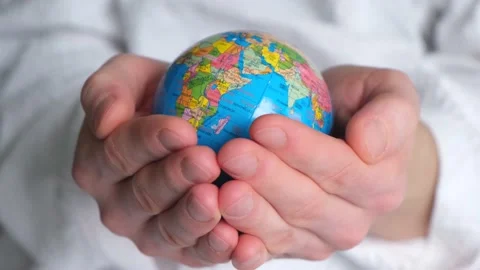 Hands holding the ground. Earth globe in hands on a white background closeup Stock Footage 154631793