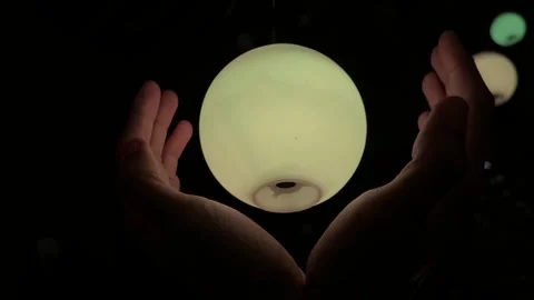 Hands Holding an illuminated Sphere Stock Footage 326085718