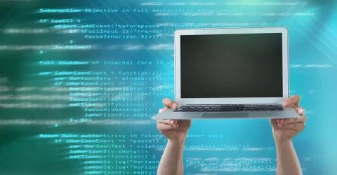 Hands holding laptop with coding text Stock Photos