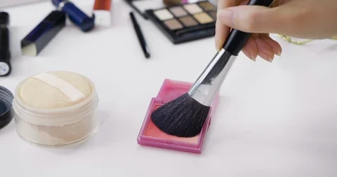 Hands holding makeup brush applying some blush Video stock 122787348