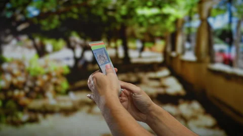 Hands holding malaysian ringgit banknotes in a sunny urban park, showcasing.. Stock Footage 304952771