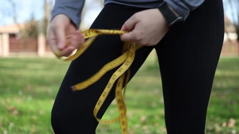 Hands holding measuring tape workout Video stock 333560719