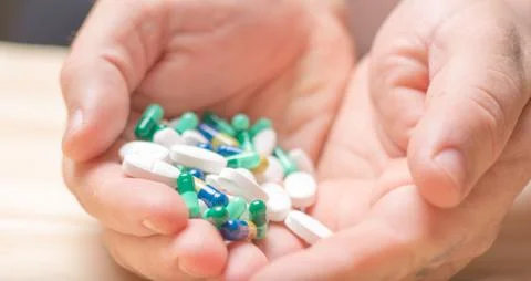 Hands holding medication Stock Photos