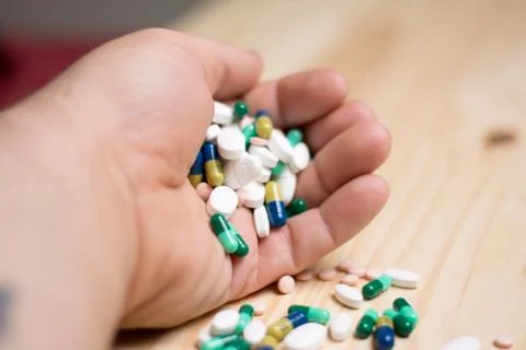 Hands holding medication Stock Photos