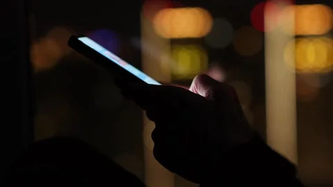 Hands holding mobile phone on the background of night city lights. Vídeo Stock 273959053