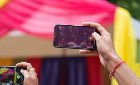 Hands holding mobile phones and shoot video Stock Photos