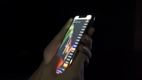 Hands holding mobile smartphone device with digital graph chart data of crypt Vídeos de archivo 156979377