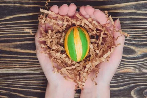 Hands holding modern painted easter egg Stock Photos