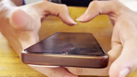Hands holding a modern smartphone 스톡 동영상 345557970
