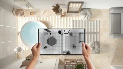 Hands holding notepad with bathroom design blueprint sketch or drawing. Real  Stock Photos