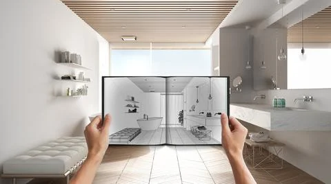 Hands holding notepad with creative bathroom design blueprint sketch or drawi Stock Photos