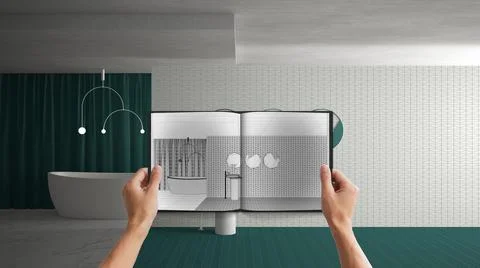 Hands holding notepad with creative bathroom design blueprint sketch or drawi Stock Photos