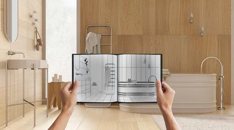 Hands holding notepad with creative bathroom design blueprint sketch or drawi Stock Photos