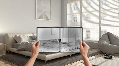 Hands holding notepad with creative bedroom design blueprint sketch or drawin Stock Photos