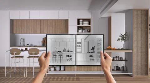 Hands holding notepad with creative kitchen design blueprint sketch or drawin Illustrazione stock