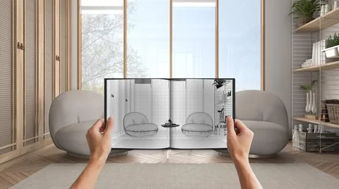 Hands holding notepad with creative lounge design blueprint sketch or drawing Illustrazione stock