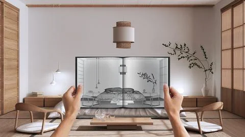 Hands holding notepad with japandi bedroom design blueprint sketch or drawing Illustrazione stock