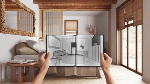 Hands holding notepad with japandi bedroom design blueprint sketch or drawi.. Illustrazione stock