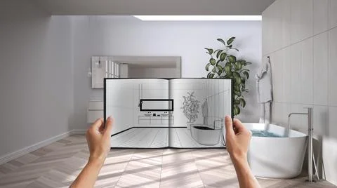 Hands holding notepad with modern bathroom design blueprint sketch or drawing Stock Photos