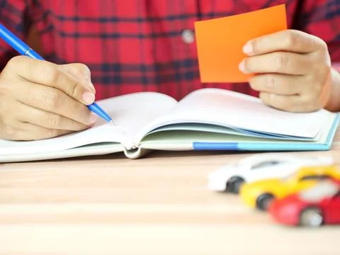 Hands holding notes with car on desk. Car insurance and finance business co.. Stock Photos