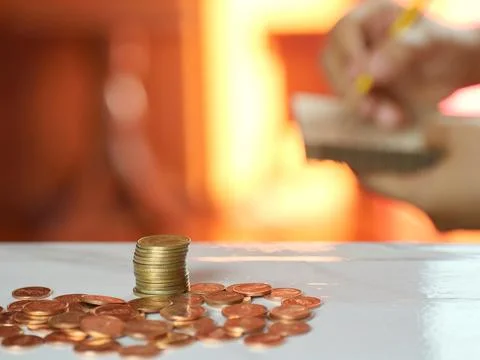 Hands holding notes with coins on desk. Saving money and financial business.. Stock Photos