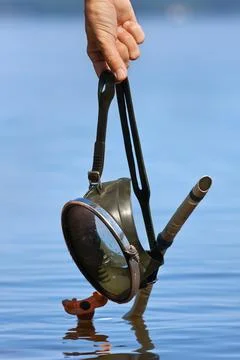 Hands holding old diving mask Stock Photos