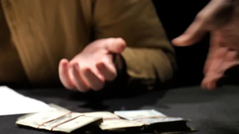 Hands holding a pack of dollars closeup which they put on the table. Stock Footage 129786633