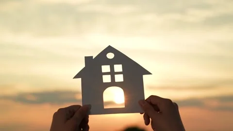 Hands holding paper house, window sunset ray, happy family mortgage build new Stock Footage 268760653