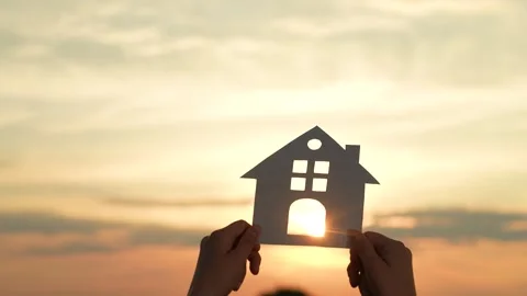 Hands holding paper house, window sunset ray, happy family mortgage build new Video stock 303224634