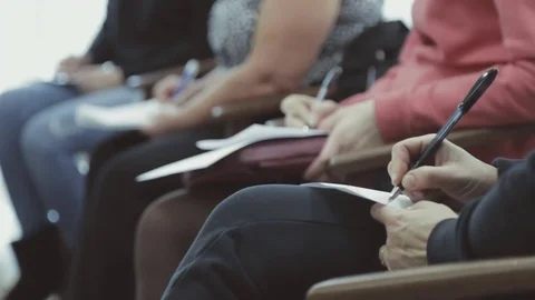 Hands holding pens and making notes at the conference Stock Footage 79622765