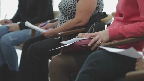 Hands holding pens and making notes at at a lecture Stock Footage 102895880