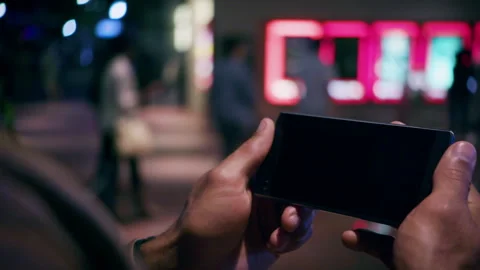 Hands holding phone screen watching content Stock Footage 298077493