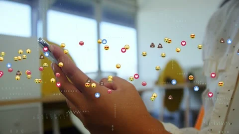 Hands holding phone, tapping and scrolling, sparking emoji waves growing to show Stock Footage 329701962