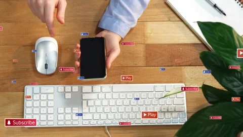 Hands holding phone tapping screen, causing Subscribe Play badges floating over Stock Footage 335282031